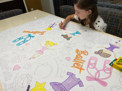 The Ballet giant coloring sheet being colored in with markers at a table