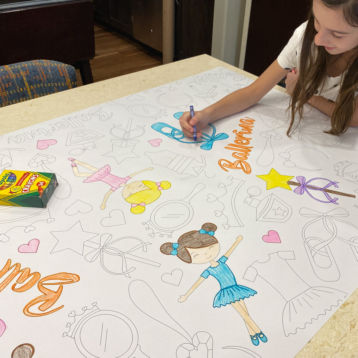 The Ballet giant coloring sheet being colored in with markers at a table