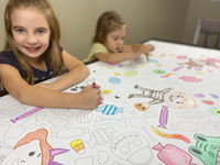 Thumbnail for The Halloween Costume giant coloring sheet being colored in with markers at a table