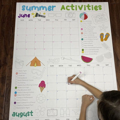 The Summer Activity Calendar giant coloring sheet being colored in with markers at a table