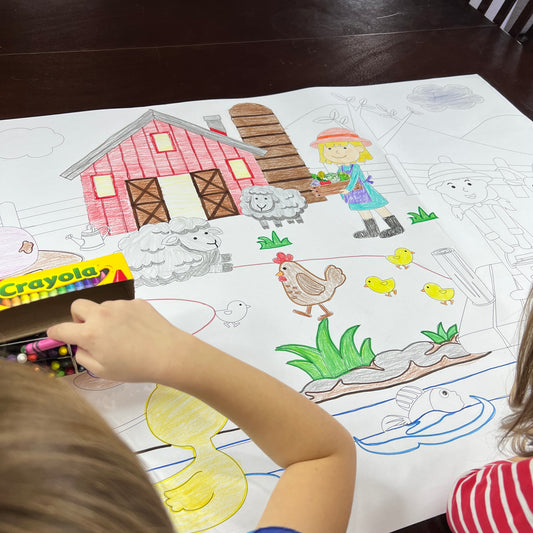 The On The Farm giant coloring sheet being colored in with markers at a table