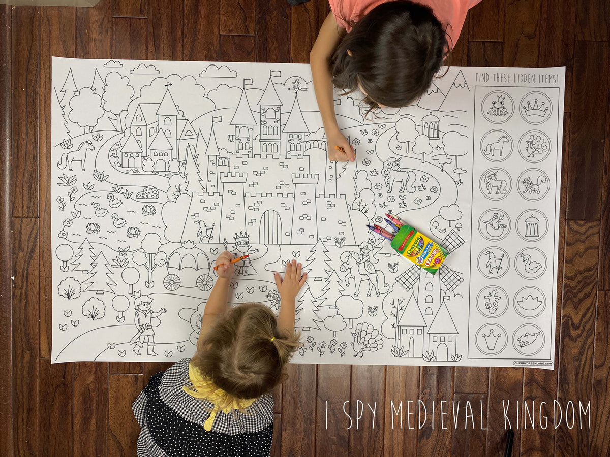 Child coloring the I Spy Medieval Kingdom giant coloring sheet on a wood floor with crayons