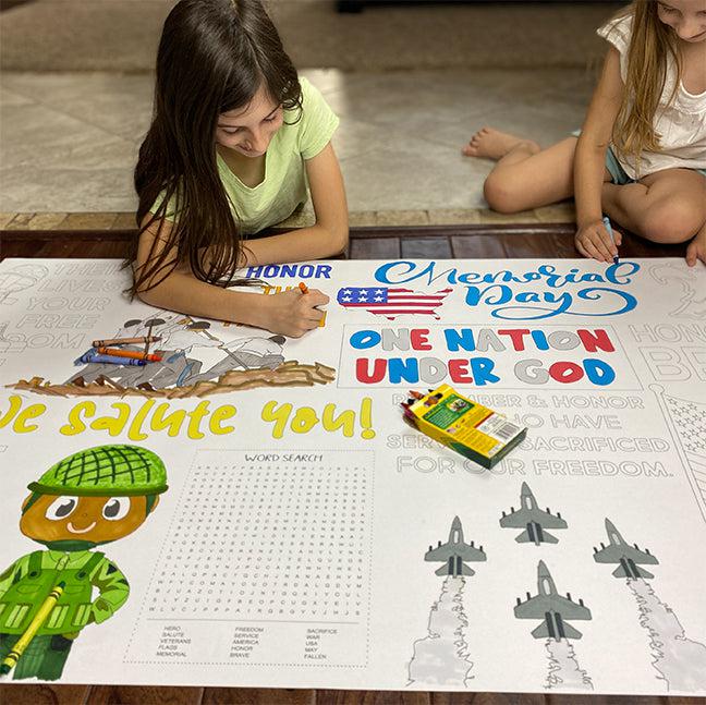 The Memorial Day giant coloring sheet being colored in with markers at a table
