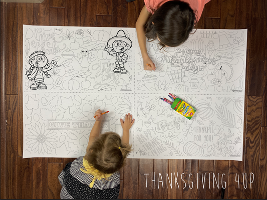 Child coloring the Thanksgiving 4-up giant coloring sheet on a wood floor with crayons