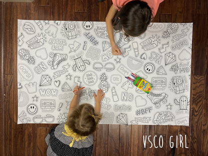 Child coloring a teen trend themed giant coloring sheet on a wood floor with crayons