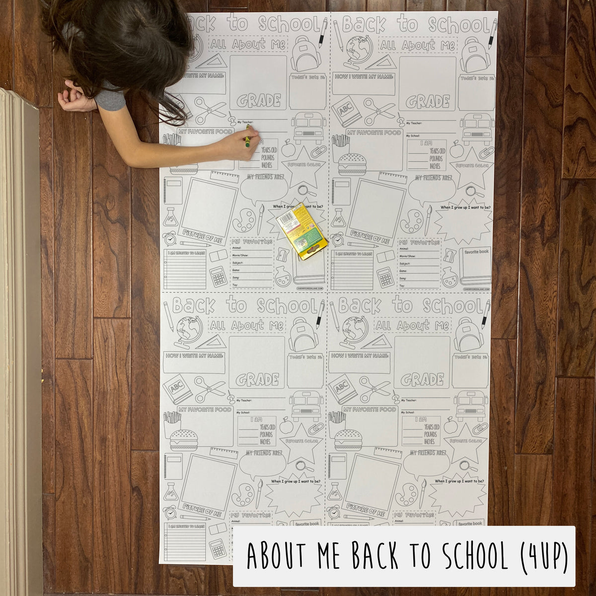 Child coloring the About Me Back to School 4-up giant coloring sheet on a wood floor with crayons