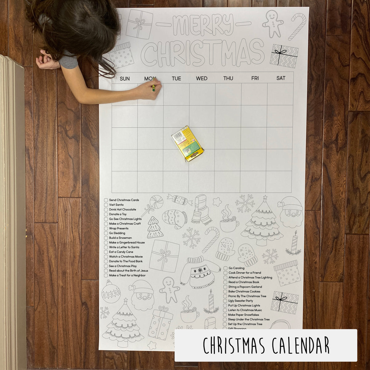 A large Christmas-themed coloring banner laid out on a table with a child coloring on it. The banner includes various Christmas motifs and text indicating days leading up to Christmas.