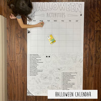 Thumbnail for Child coloring the Halloween Activity Calendar giant coloring sheet on a wood floor