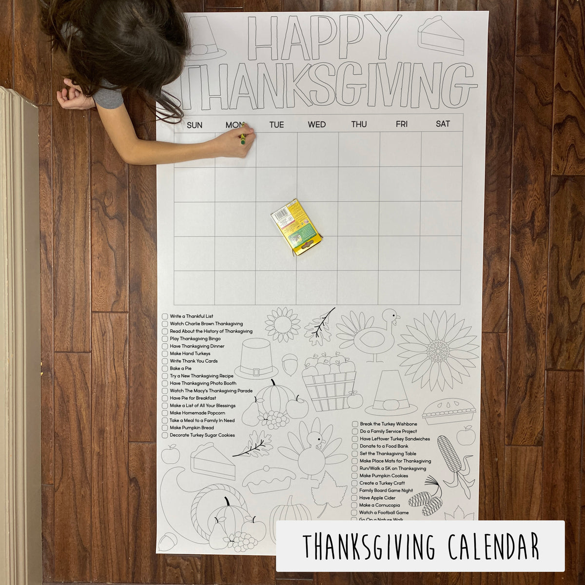 A large Thanksgiving-themed coloring sheet displayed on a wooden table with a child coloring on it. The sheet has various sections for each day of the week with Thanksgiving-related illustrations.
