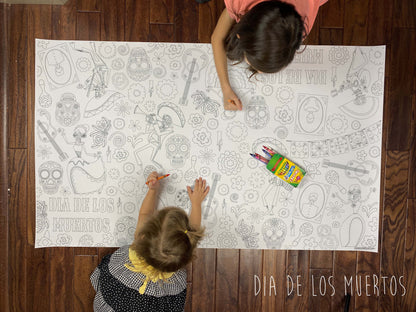 Child coloring the Dia De Los Muertos giant coloring sheet on a wood floor with crayons
