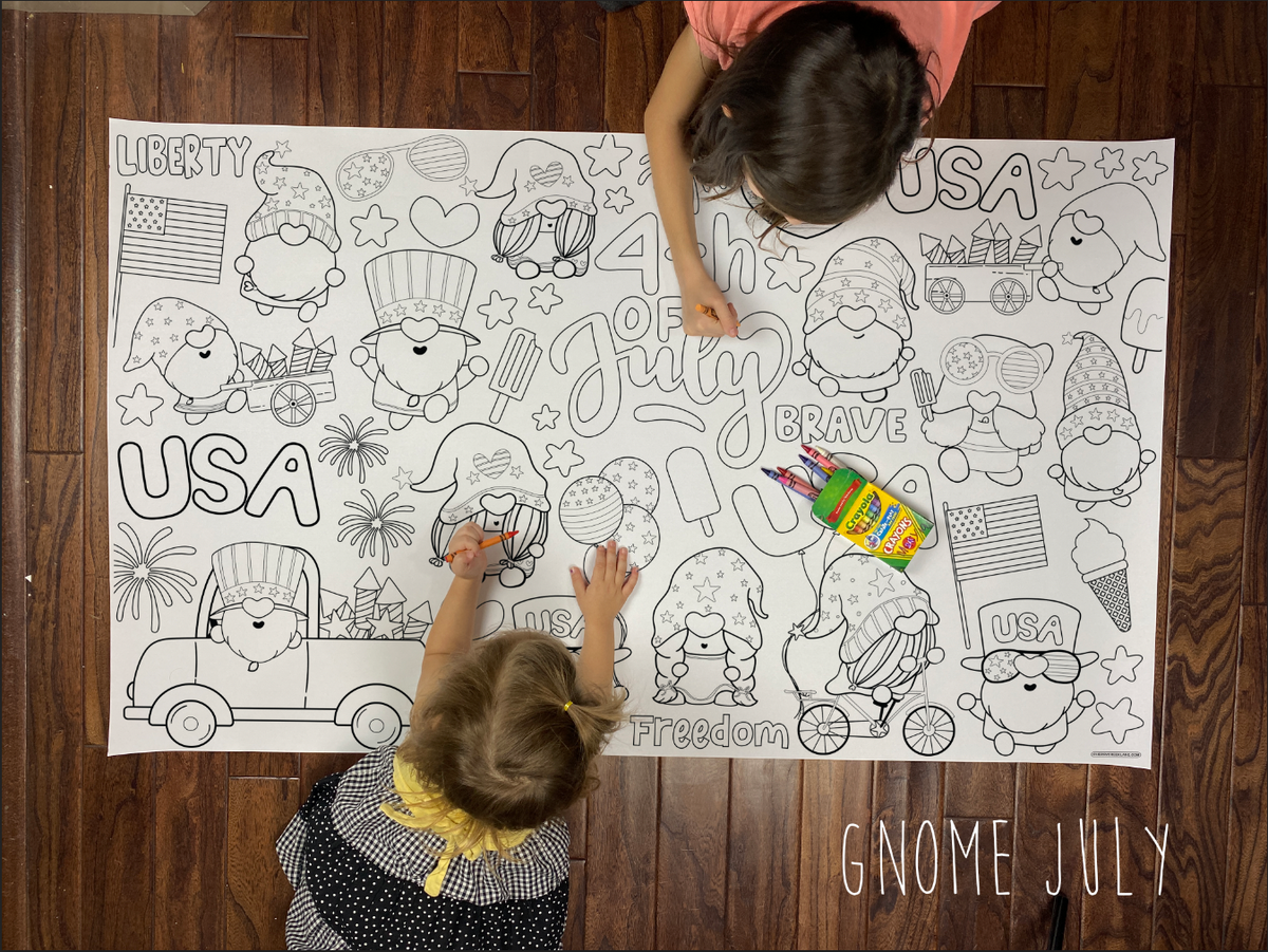 Child coloring the Gnome 4th of July giant coloring sheet on a wood floor with crayons