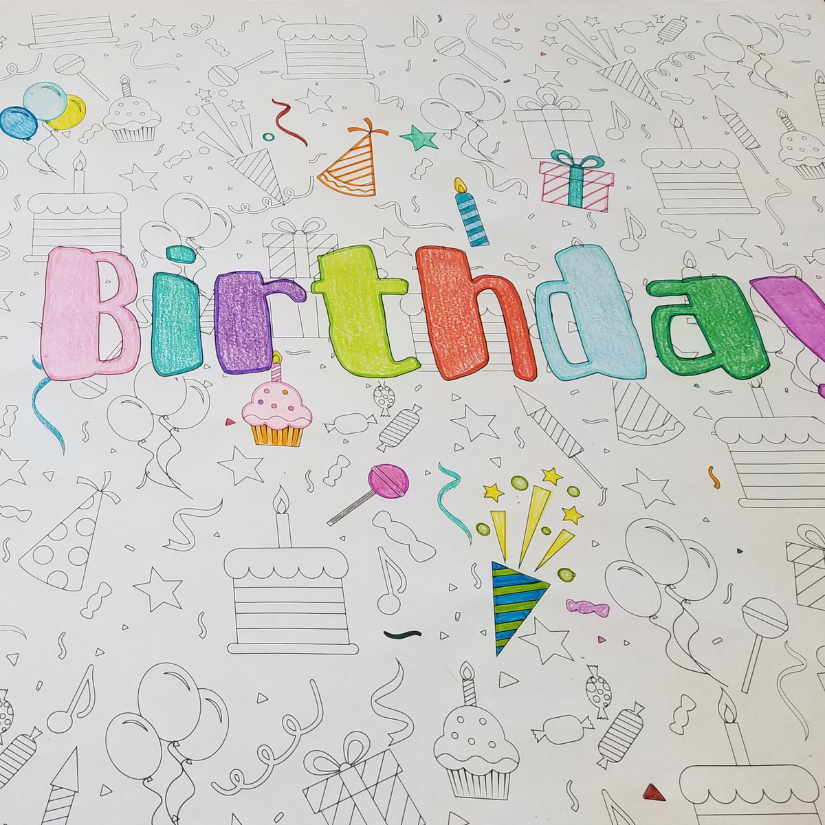 Close-up of the Happy Birthday coloring sheet colored in with markers