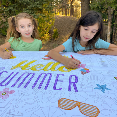 The Summer giant coloring sheet being colored in with markers at a table