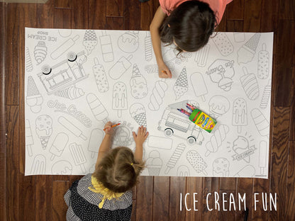 Child coloring the Ice Cream Fun giant coloring sheet on a wood floor with crayons
