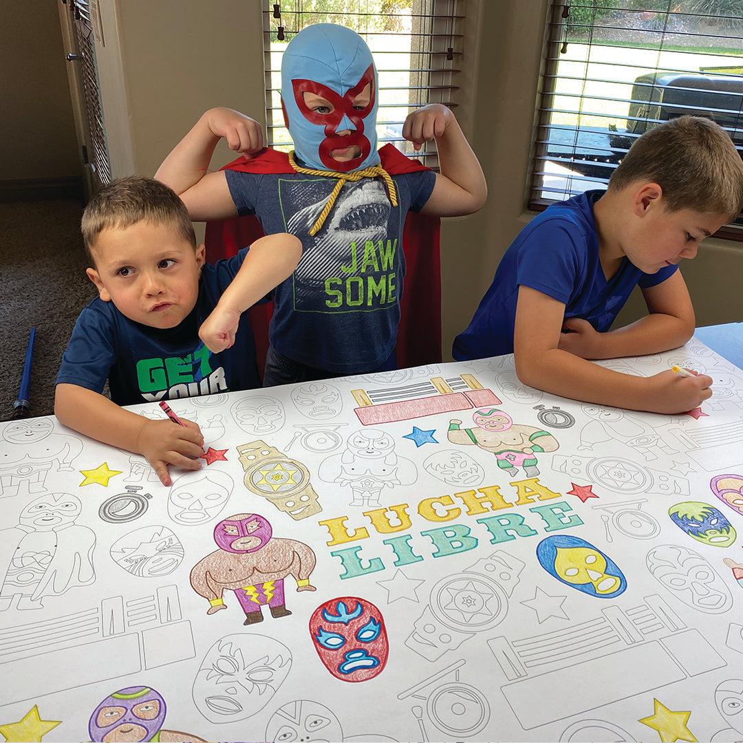 The Lucha Libre giant coloring sheet being colored in with markers at a table