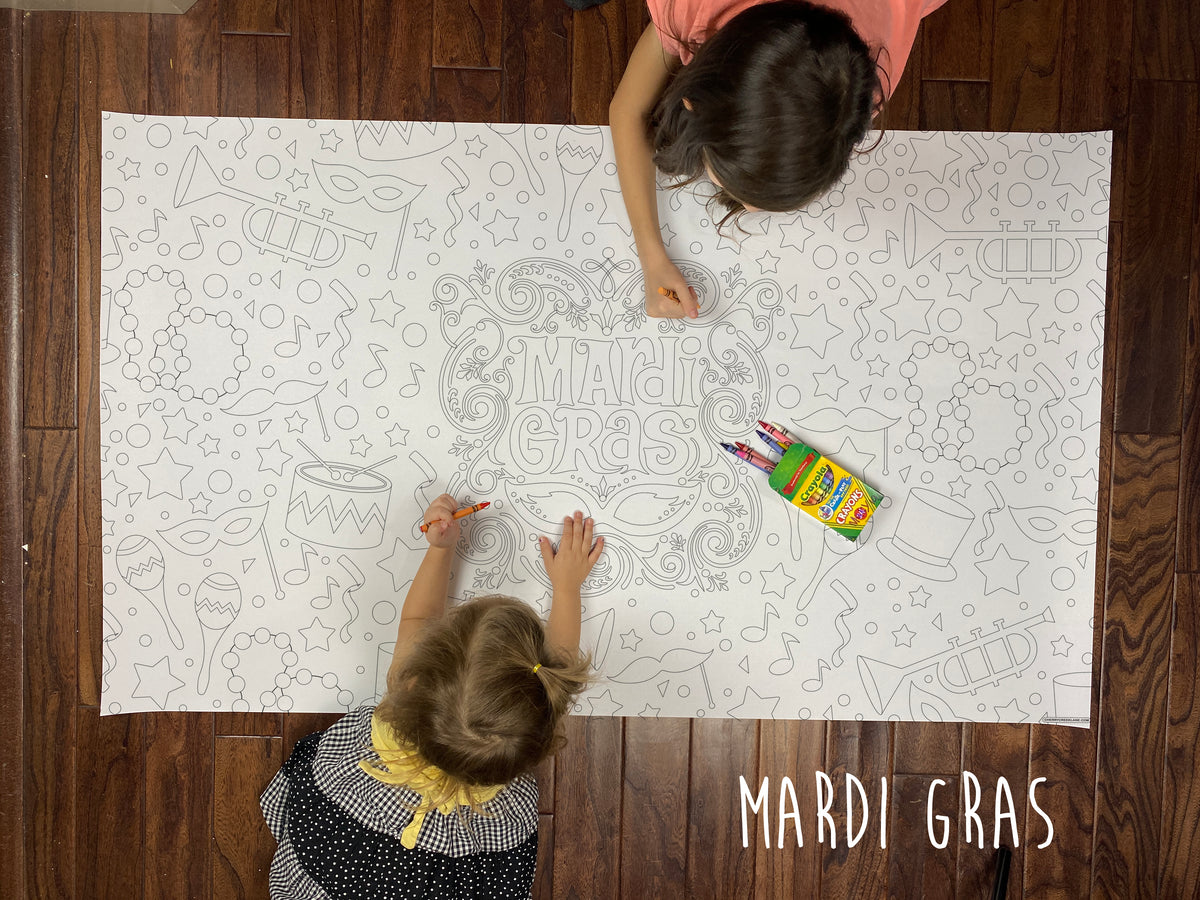 Child coloring the Mardi Gras giant coloring sheet on a wood floor with crayons
