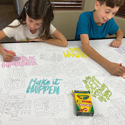 The Motivation Quotes giant coloring sheet being colored in with markers at a table