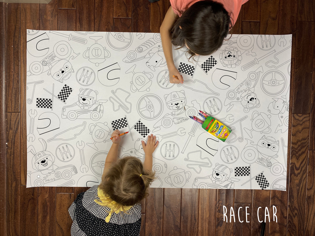 Child coloring the Race Car giant coloring sheet on a wood floor with crayons