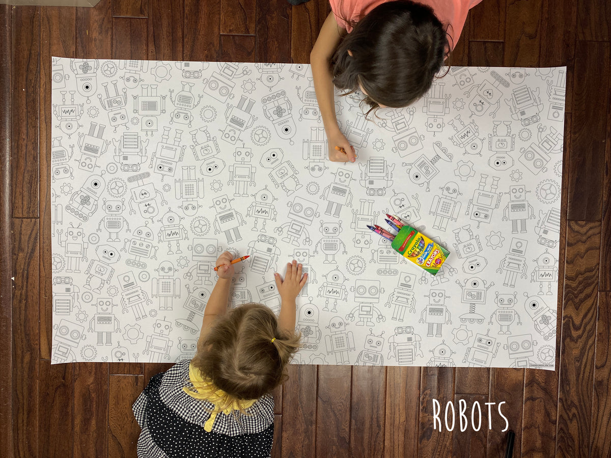 Child coloring the Robot giant coloring sheet on a wood floor with crayons