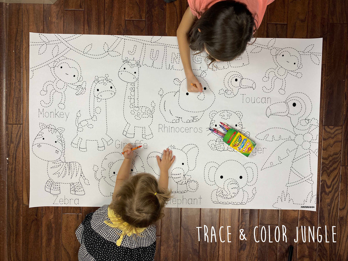 Child coloring the Jungle Trace & Color giant coloring sheet on a wood floor with crayons