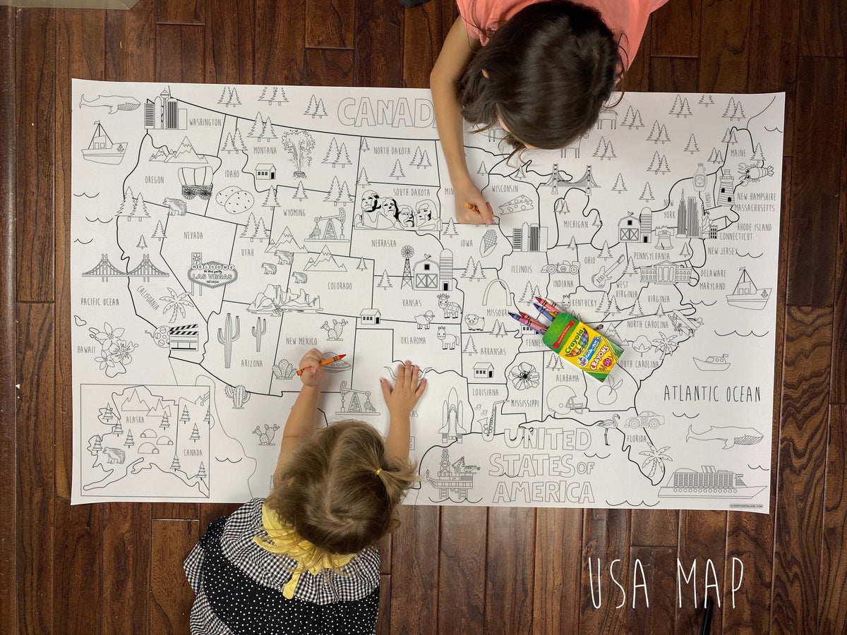 Child coloring the USA giant coloring map on a wood floor