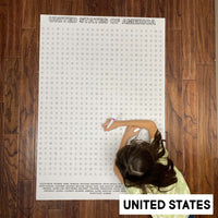 Thumbnail for Child solving the United States giant word search poster on a wood floor