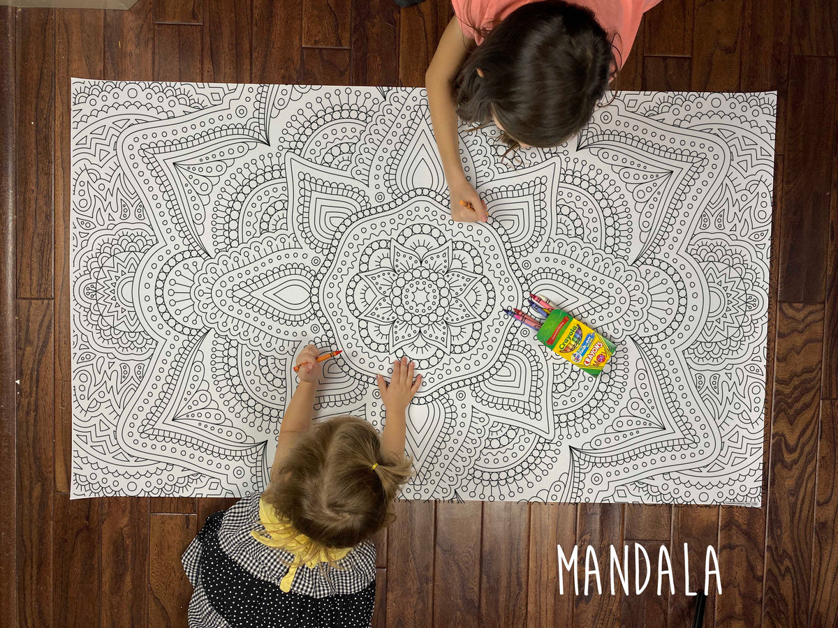 Child coloring the Zentangle Mandala giant coloring sheet on a wood floor with crayons