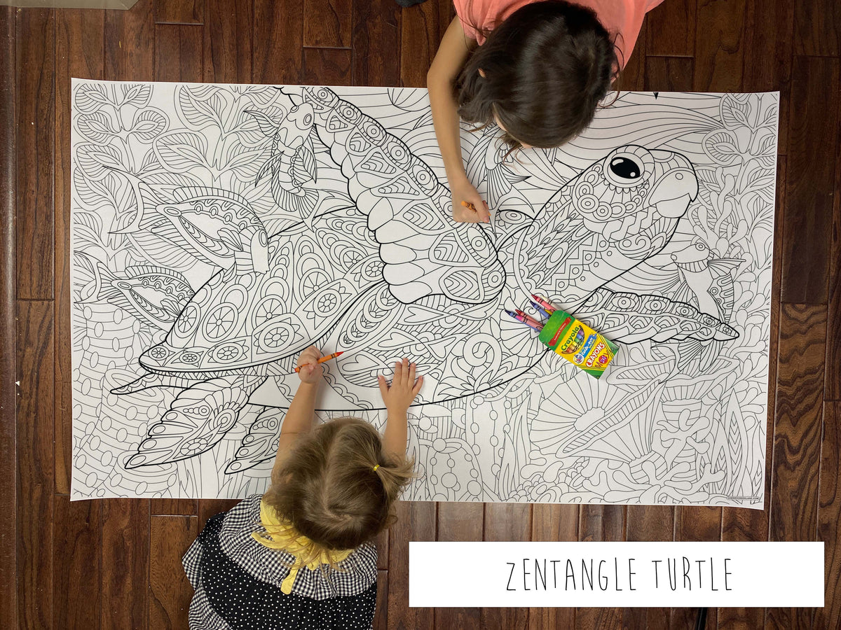 Child coloring the Zentangle Turtle giant coloring sheet on a wood floor with crayons