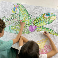 Thumbnail for The Zentangle Turtle giant coloring sheet being colored in with markers at a table